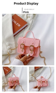 Detailed view of pink jelly crossbody bag with gold buckles and fine chain strap
