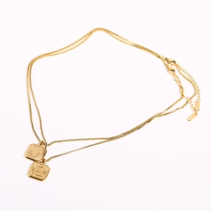 Detail of gold double-layer necklace with V and E square pendants and K18 S925 hallmarking