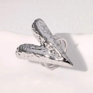 Macro detail of silver vintage heart ring with hammered texture and polished metal finish