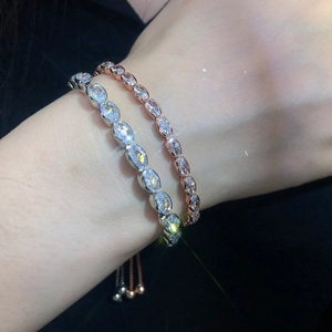 Adjustable oval cubic zirconia tennis bracelet in silver and rose gold finishes