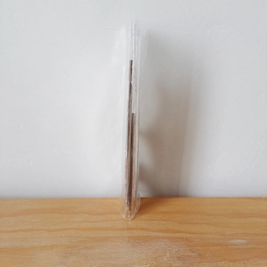 Side view of a 3D wooden Christmas letter frame ornament sealed in clear plastic packaging