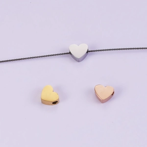 Three mirror polished heart charms in silver, gold and rose gold for DIY jewelry making