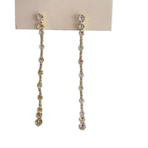 Elegant gold-plated tassel earrings with round cubic zirconia crystals on white background