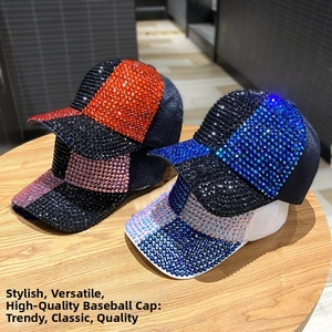Close-up of sparkling full rhinestone baseball caps in multiple colors on a wooden table