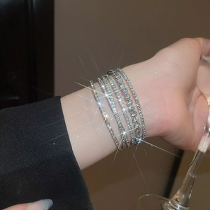 Detailed view of silver multi-layer tennis bracelets with sparkling zircon stones