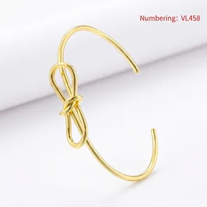 Detail view of gold-plated twisted bow bangle with a 2.0mm wire diameter specification