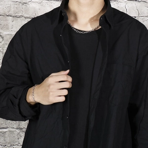 Detailed view of men's silver O-chain necklace and bracelet set on a stylish model