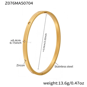 Detail view of gold stainless steel geometric bangle with zircon inlay and product specs