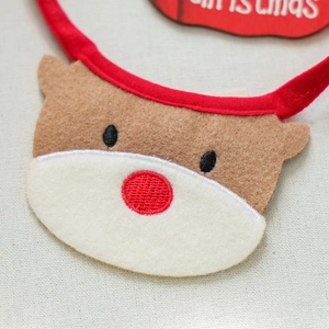 Close-up of reindeer dog bandana with embroidered red nose and felt texture