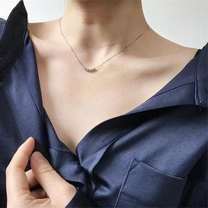 Minimalist silver necklace featuring six sliding metal beads on a sleek chain link