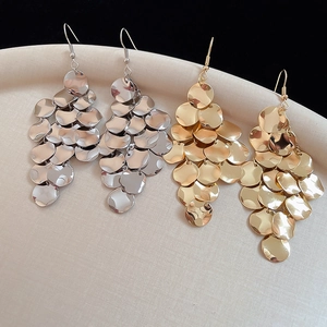 Detailed view of layered metallic sequin fringe earrings in gold and silver finish
