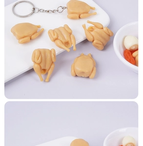 Detailed view of mini 3cm realistic roasted chicken keychain on a white plate