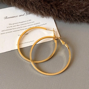 Polished golden geometric hoop earrings with flat surface design and shiny metallic finish