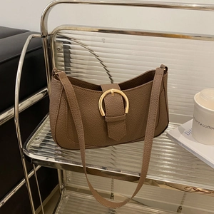 Detailed close-up of dark brown lychee pattern PU leather bag with golden ring buckle
