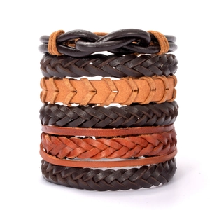 Detailed view of stacked multilayer woven leather bracelets in brown and tan tones