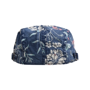 Detail view of denim ivy cap featuring floral print and bronze metal adjustment buckle