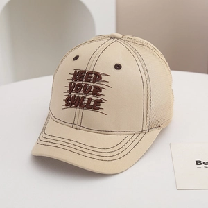 Detail of KEEP YOUR SMILE embroidery on a beige mesh baseball cap for kids