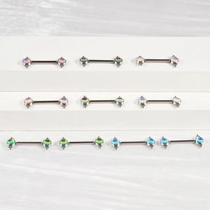 Macro detail of stainless steel body jewelry pins with iridescent opal balls