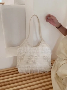 Summer casual white lace mesh shoulder bag with pleated ruffles on a wooden bench