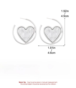 Detail view of silver heart hoop earrings with marble texture and dimensions
