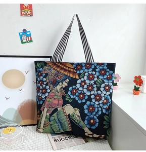 Detail of artistic jacquard tote bag featuring floral ethnic girl illustration pattern