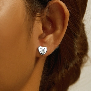 Close-up of S925 sterling silver heart stud earring with Dad engraving and crystal