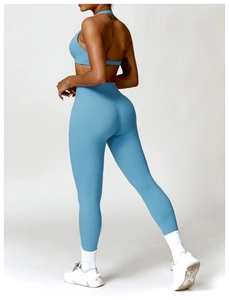 Detail view of high-waist scrunched butt yoga leggings and matching sports bra back
