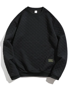 Detailed flat lay of black waffle knit sweatshirt texture and crew neck design