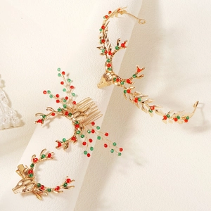 Detailed view of 3-piece Christmas gold reindeer hair accessories with red and green beads