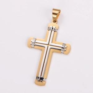 Macro shot of two-tone stainless steel cross pendant with gold brushed finish and silver inlay