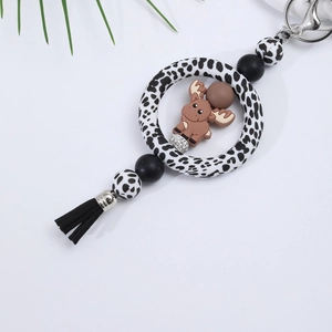 Close-up of silicone reindeer charm with leopard print ring and black tassel detail