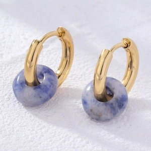 Detailed close-up of golden huggie hoop earrings with blue natural sodalite stone beads