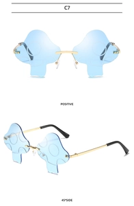 Close-up of mushroom shaped rimless sunglasses with blue wavy lenses and gold metal frame