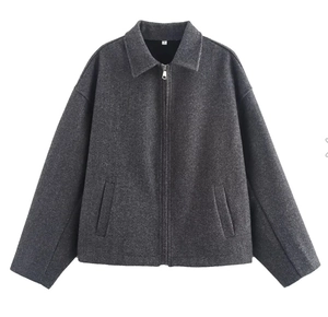 Detail of dark grey short wool jacket with zipper and lapel collar on white background