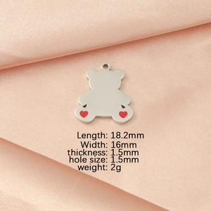 Detailed view of bear pendant dimensions 18.2x16mm with red heart on silk fabric