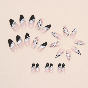 Almond-shaped zebra pattern press-on nails with silver glitter and ribbon design accents