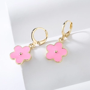 Gold-plated floral earrings with pink enamel flower petals on white background