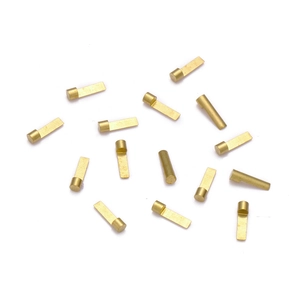 Detailed macro view of precision brass charging contact pins for wireless earbuds