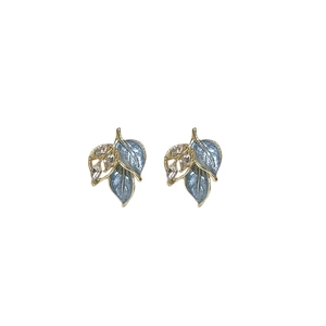 Vintage leaf stud earrings with light blue enamel and clear crystals on a white background