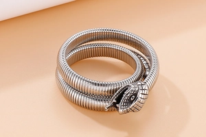 Detail of vintage silver cobra bracelet showing textured snake scales and dual coil wrap