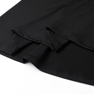 Detail view of the high-quality double-stitched hem on the black halter maxi dress