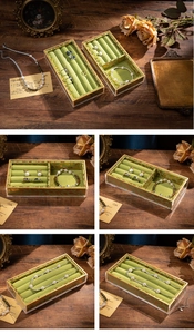 Detailed view of green velvet jewelry tray with gold patterns and acrylic frame for rings