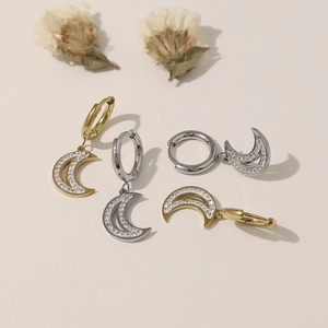Polished crescent moon stud earrings in gold and silver with inlaid cubic zirconia