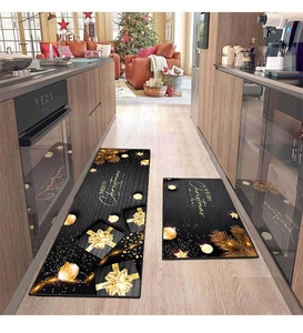 Two-piece black kitchen mat set with golden Merry Christmas patterns and gift motifs