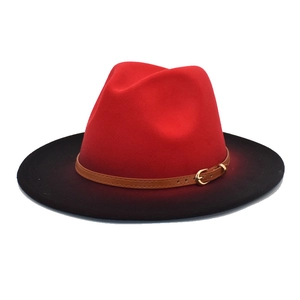 Close-up of red and black ombré fedora hat with a brown faux leather buckle belt