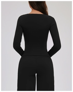 Slim fit black long sleeve yoga set showing back view of fabric stretch and seam detail