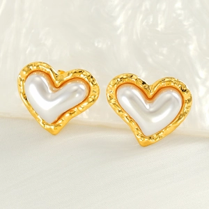 Detail of 18k gold plated vintage pearl stud earrings with heart shape and silk texture