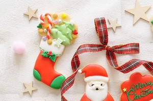 Detail of Christmas snowman and house cookie cutters with festive icing cookies