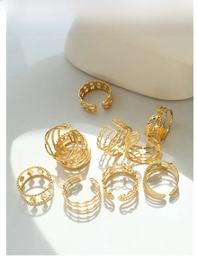 Diseño artístico de varios anillos geométricos ajustables bañados en oro sobre piedra