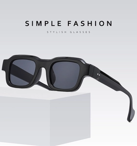 Detail view of square black sunglasses with wide temples and silver dot accents